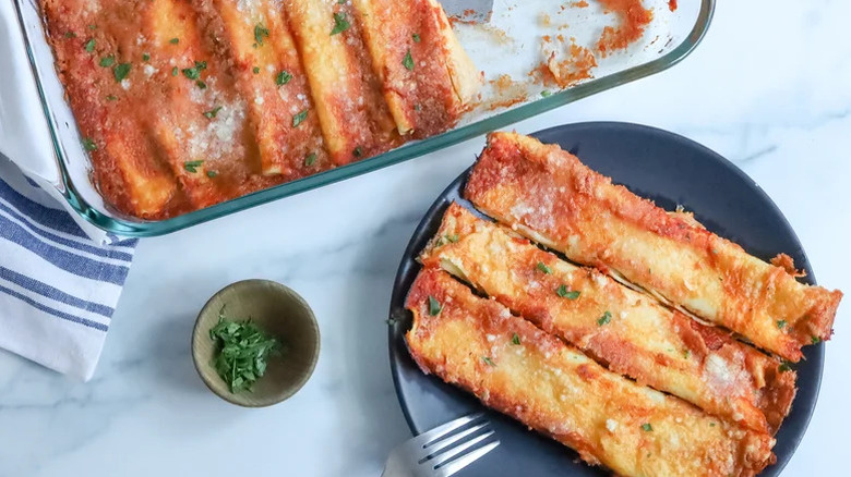 plate of crespelle next to big dish
