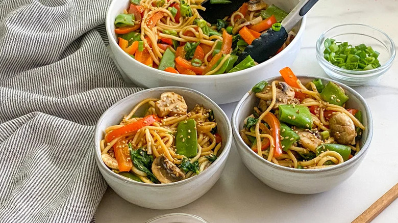 two small bowls of lo-mein and big bowl