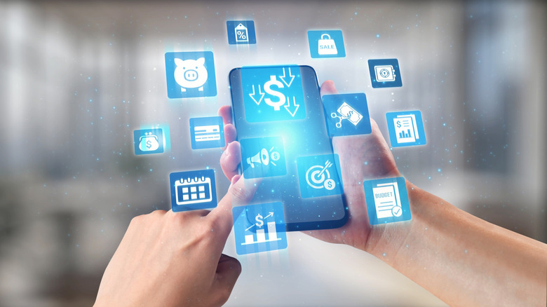 Hand holding a phone screen with blue icons