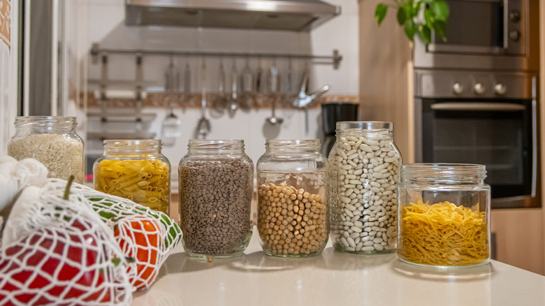 Several pantry essentials placed in glass containers on counter
