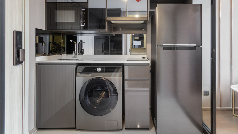 Hand unplugging power cord from electrical outlet on wall