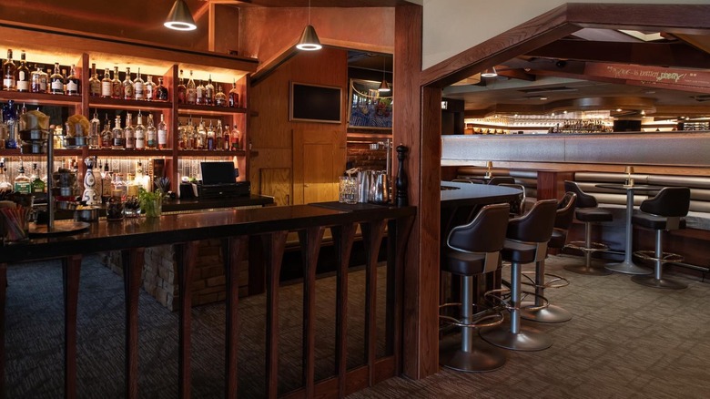 Dark wood bar area with stools