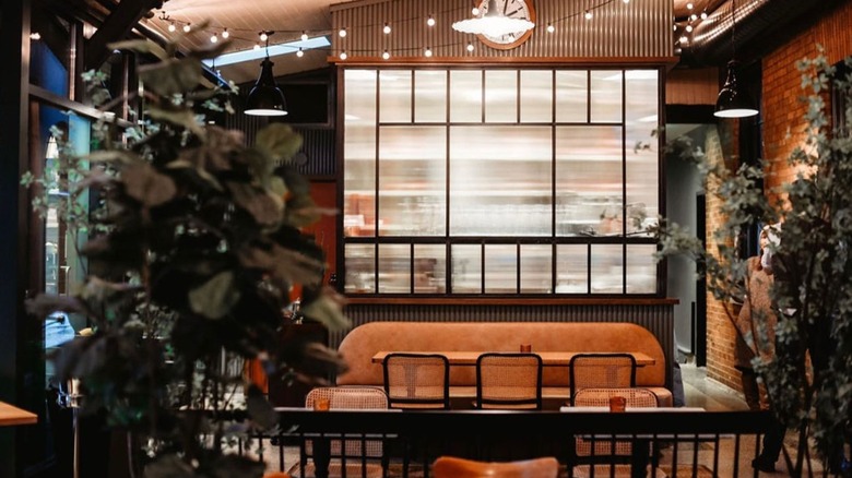 Interior seating of The Harvey House with hanging lights and plants