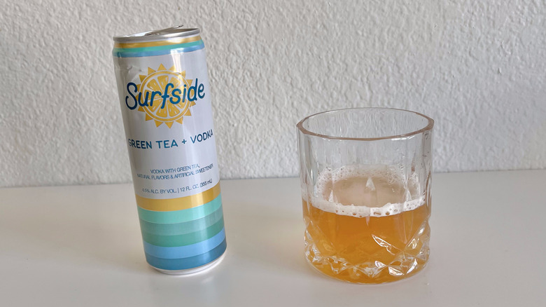 Green Tea + Vodka can with a glass next to it