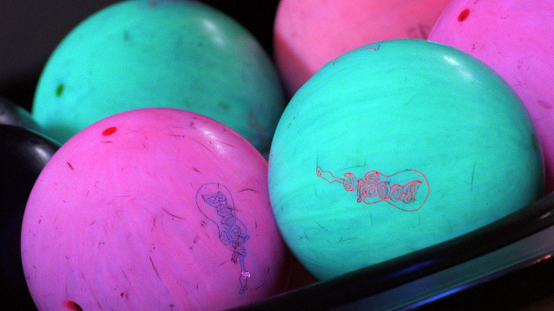 Glowing bowling balls under black lights