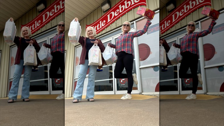 Two ladies with bags full of snack cakes coming out of a Little Debbie bakery store