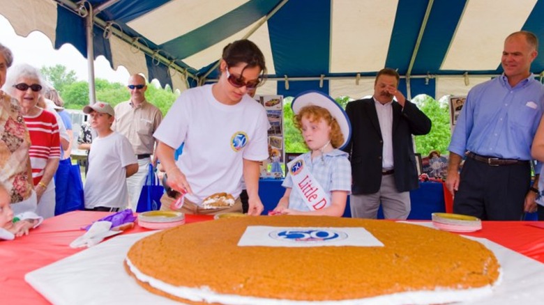 Little Debbie look-alike getting a piece of the 50th anniversary oatmeal creme pie
