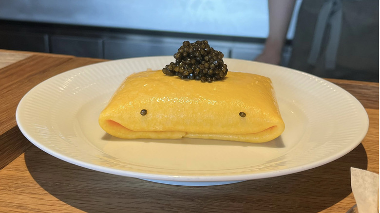 egg dish on a plate with caviar on top