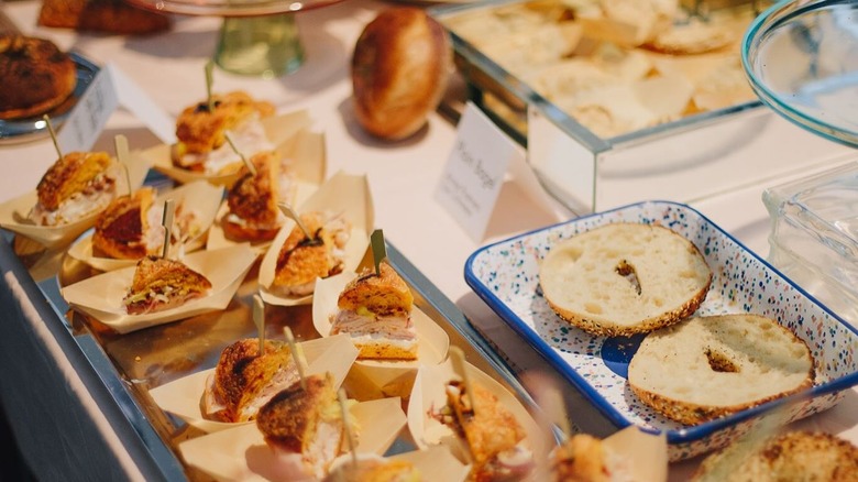 counter with bagel and cut up bagel sandwiches