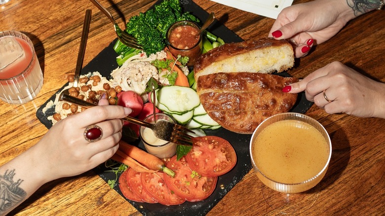 appetizers in center of restaurant table with women's hands