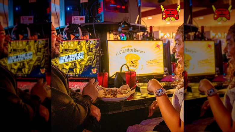 A couple eating food at Battle & Brew