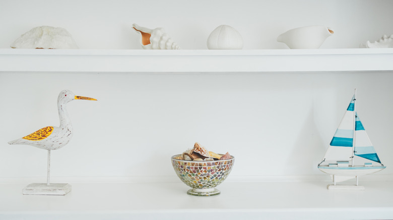 Marine-themed decor on white open shelves