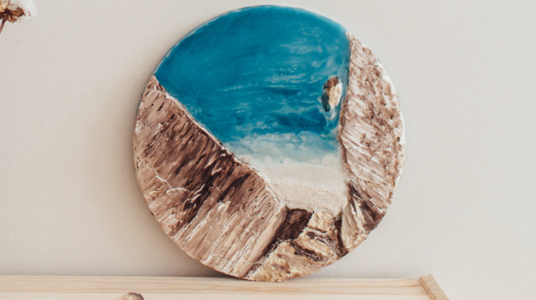 Handmade ocean wave resin decor placed on wooden table