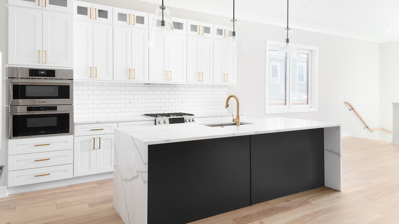 Luxury white kitchen with waterfall island