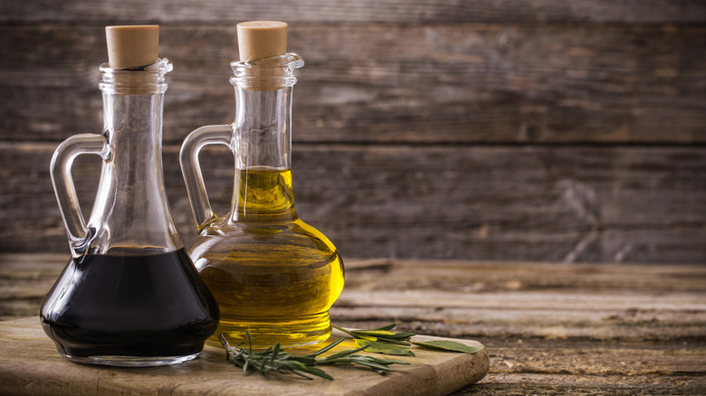 Olive oil and balsamic vinegar on a rustic wood background