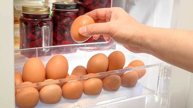 A refrigerator bin full of eggs