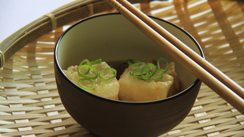 A bowl of Agedashi Tofu with chopsticks