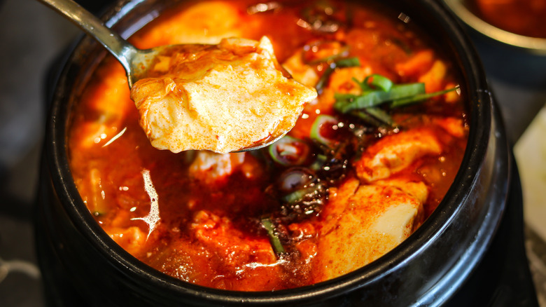 Sundubu-jjigae being eaten with spoon