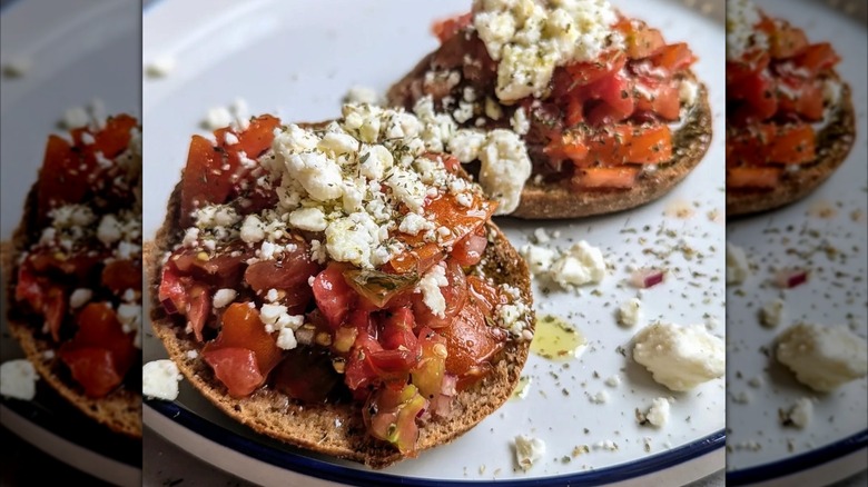 Mirrored image of Cretan dakos on a white plate