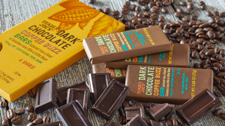 Bars of Trader Joe's Dark Chocolate Coffee Buzz on a table surrounded by coffee beans and chocolate squares