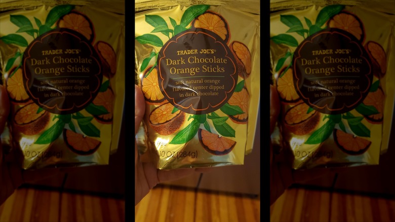 A person holding a bag of Trader Joe's Dark Chocolate Orange Sticks