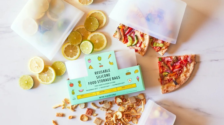 Trader Joe's reusable silicone food storage bags on a countertop surrounded by food and snacks