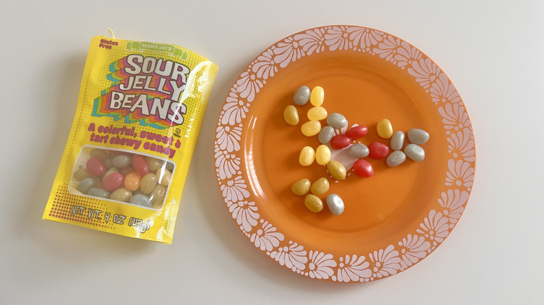 Bag of sour jelly beans with some sour jelly beans on a plate