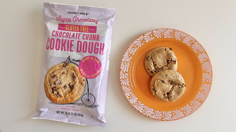 Package of Super Chocolatey Gluten Free Chocolate Chunk Cookie Dough cookies from Trader Joe's with two cookies on the side