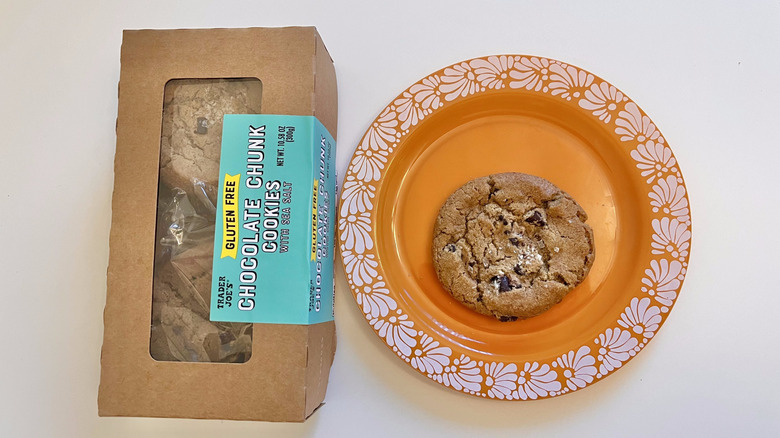 Chocolate chunk cookies in package with one cookie displayed on an orange plate