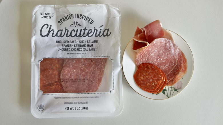 Spanish charcuterie package on a table next to a dish of cured meats