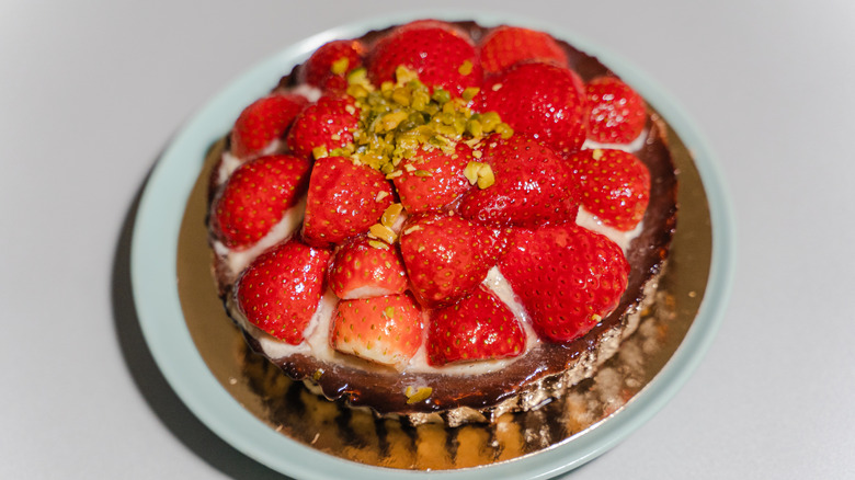 Danish strawberry tart with cream on a gold plate
