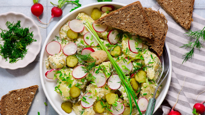 Scandinavian potato salad with rye bread and garnishes