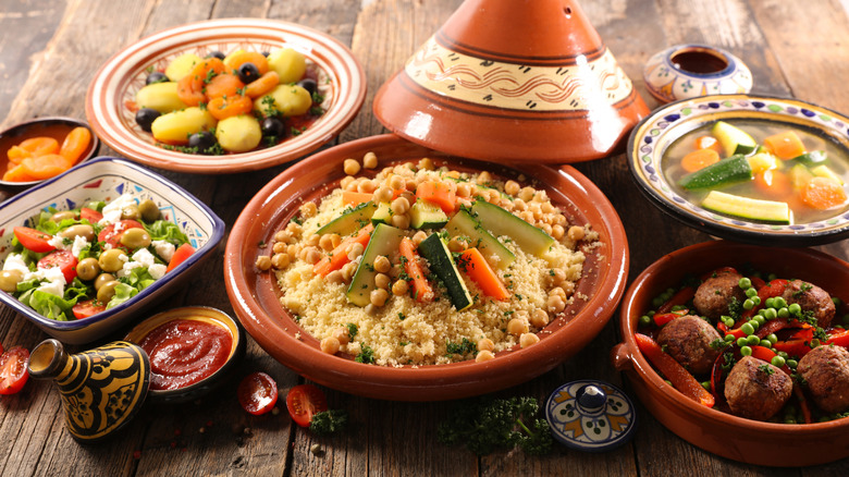 Various Moroccan dishes served in bowls and tagine