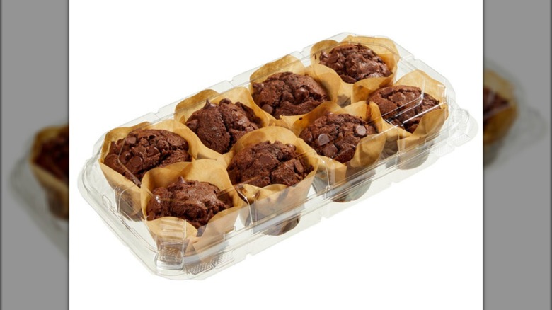 A plastic container of eight chocolate muffins
