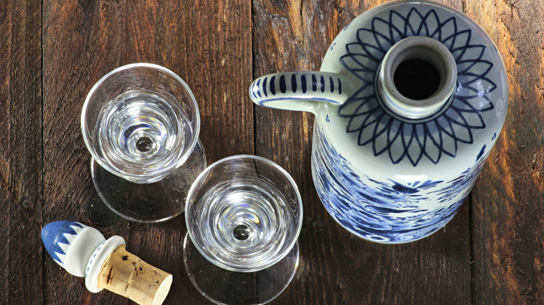 Porcelain jug and stopper with two glasses of genever from above