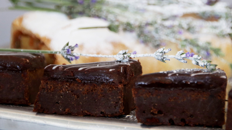 Chocolate lavender brownies on a plate topped with lavender.