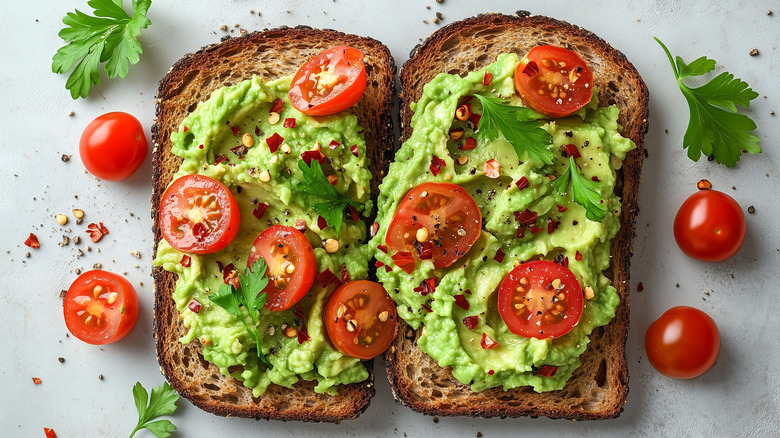 Two pieces of avocado toast with tomatos