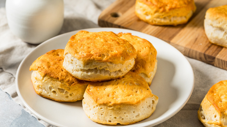 A white plate with biscuits stacked on top