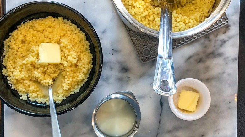 Bowls of acini di pepe with butter