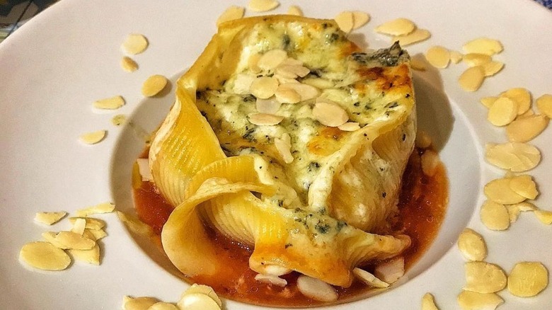 Large caccavelle shell holding a creamy filling topped with toasted almonds