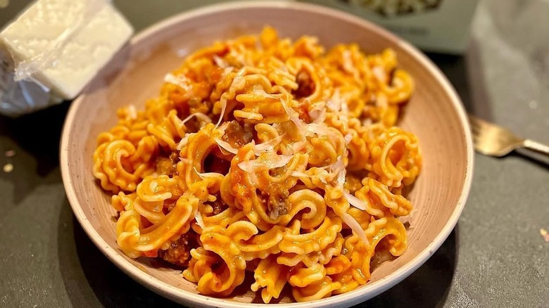 Pasta served with a tomato sauce and topped with parmesan