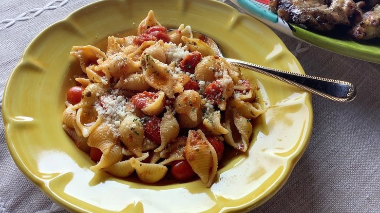 Bowl of Conchiglie with tomato-based sauce and Parmesan