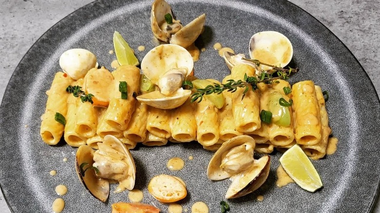 Beautifully plated pasta with clams, rosemary, lemon juice, and creamy sauce