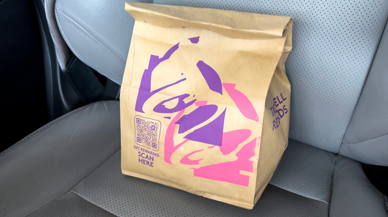 Taco Bell bag sitting in car seat