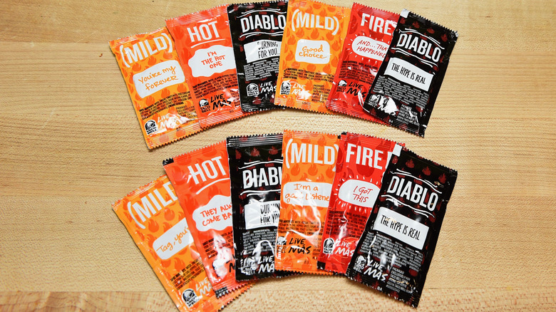 An array of different varieties of Taco Bell sauces