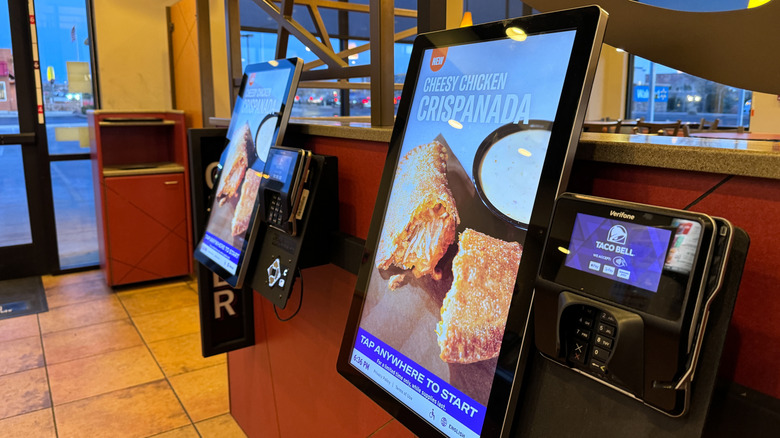 Two Taco Bell order kiosks inside restaurant