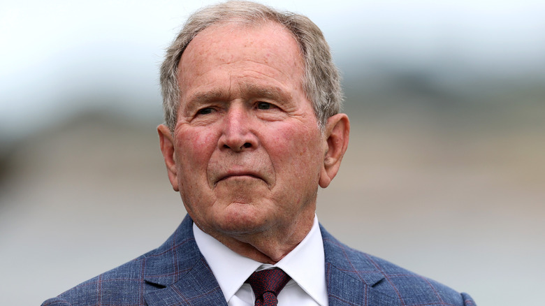George W. Bush in suit against blurred background