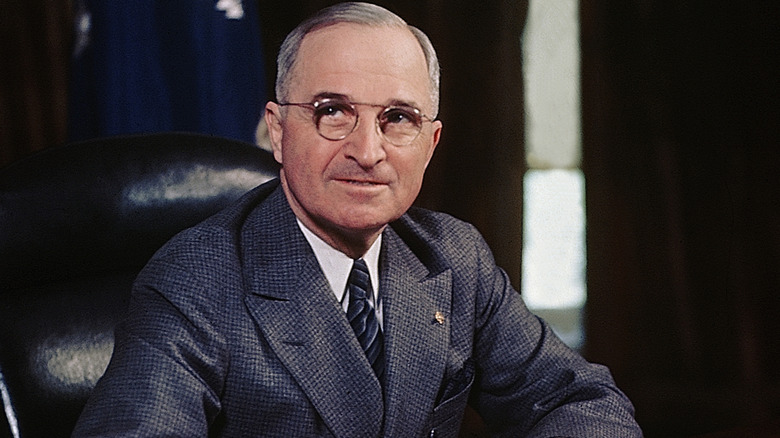 color photo of Harry S. Truman wearing suit in chair