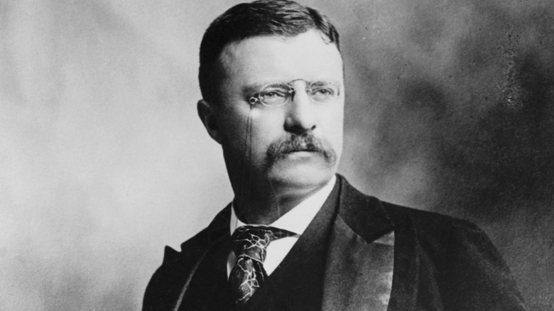 black and white portrait of Theodore Roosevelt wearing a suit with monocle
