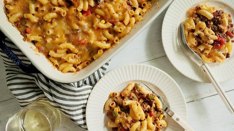 Cheesy beef and macaroni casserole served from baking dish onto plates